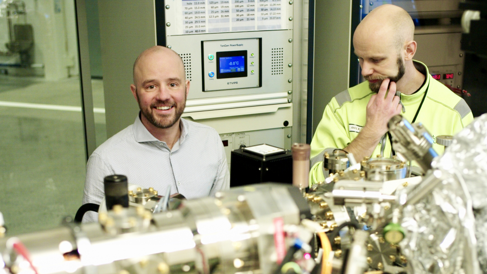 Photo of two men in industrial research area.