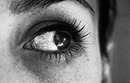 Närbild av en kvinnas öga som tittar uppåt åt sidan