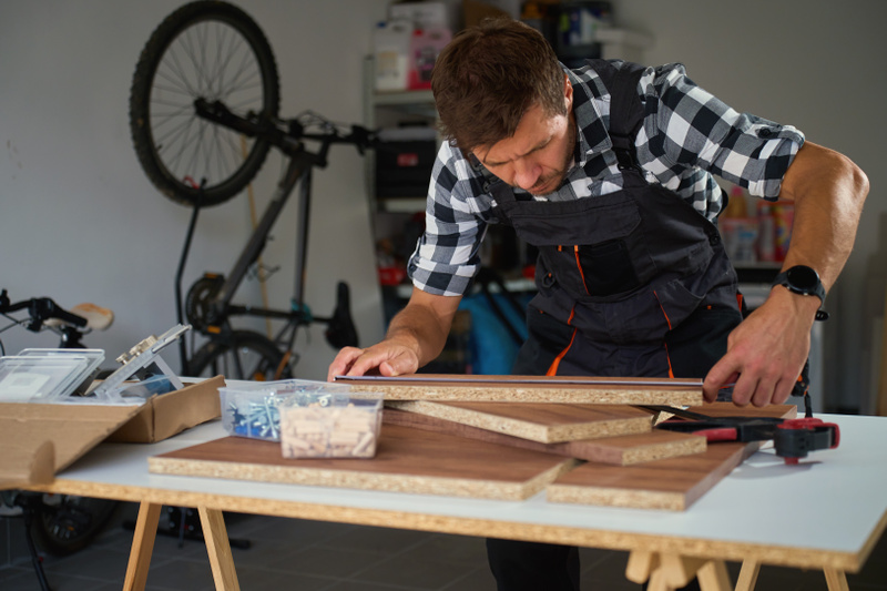 3892 mp68782520 carpenter measuring wooden boards in workshop