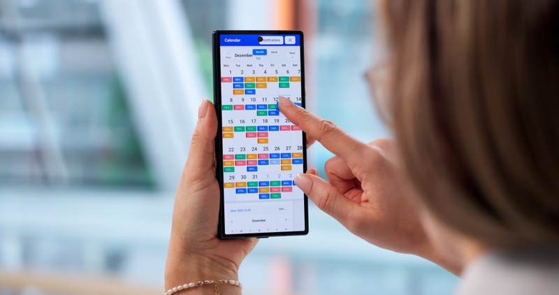 4075 mp69671201 busy businesswoman using smartphone to manage calendar