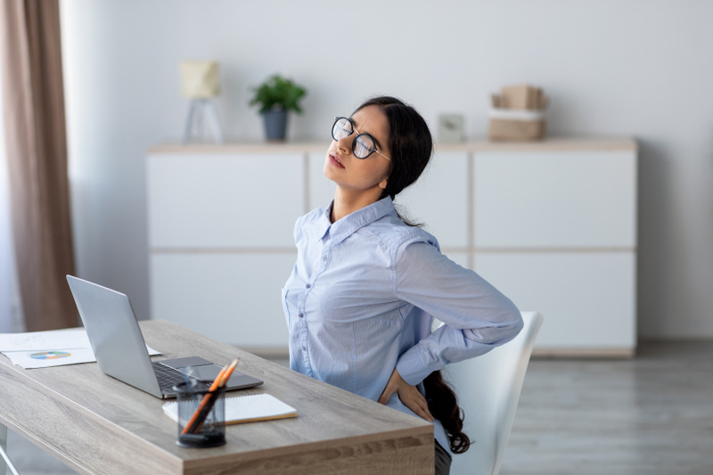 4181 mp69115244 young indian business woman struggles with back pain
