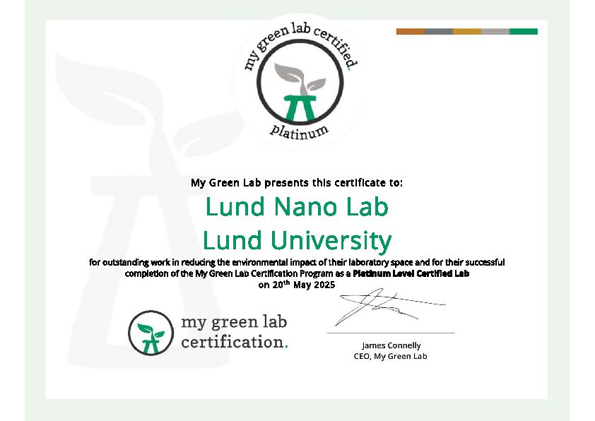 Photo of three people with diplomas and flowers.