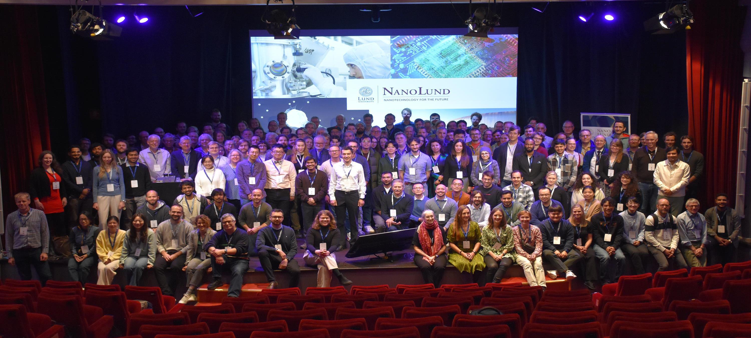 Photo of lots of people standing on a scene.