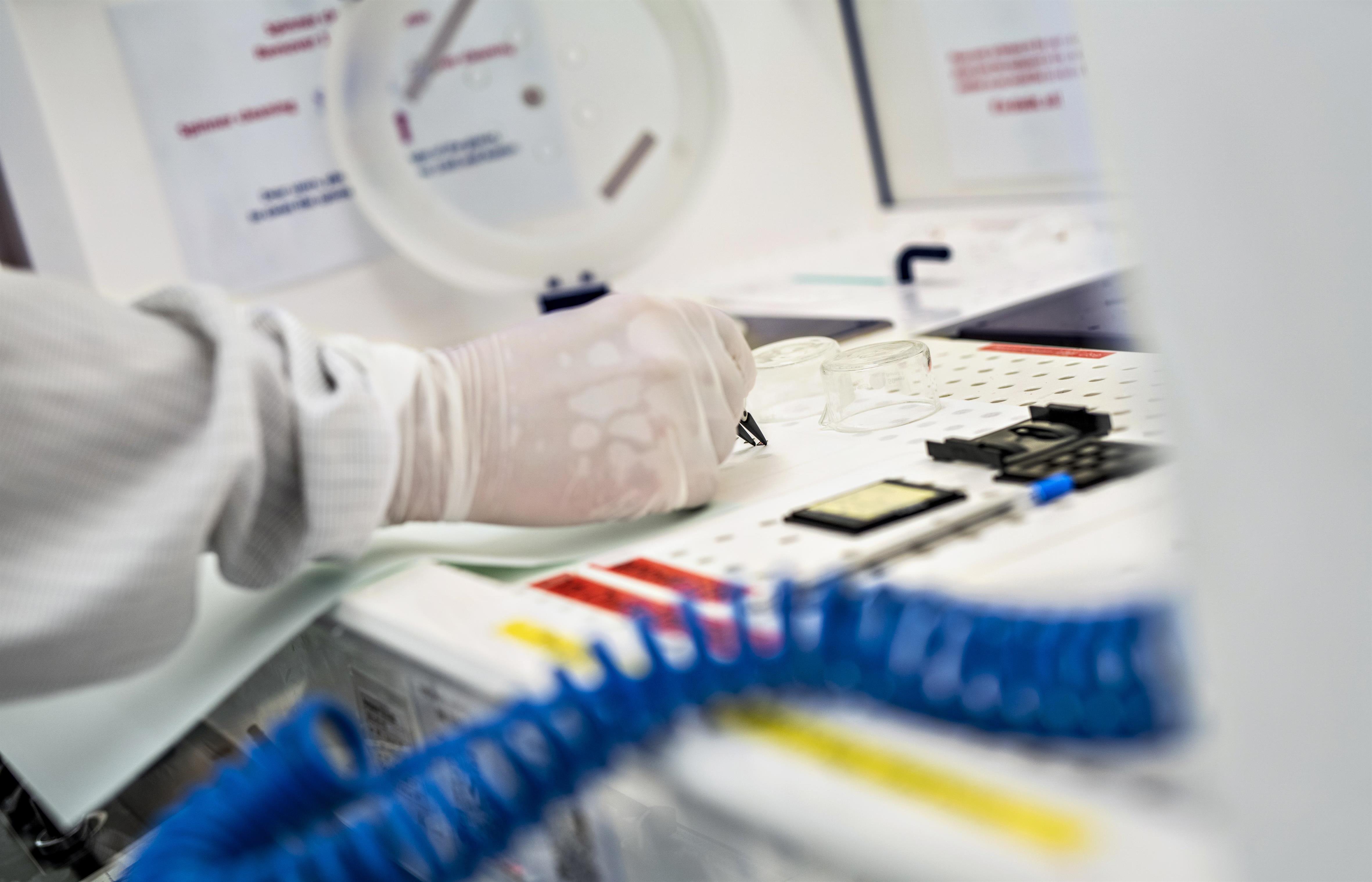 Photo of hands working with scientific devices.