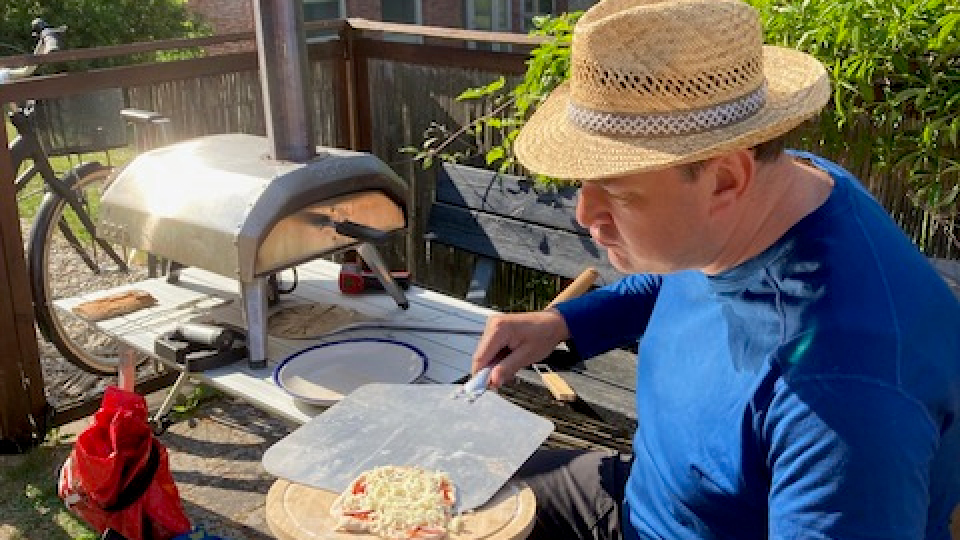 Jens Uhlig making pizza in the lovely summer afternoon.