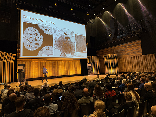 Photo of a woman presenting on a stage.