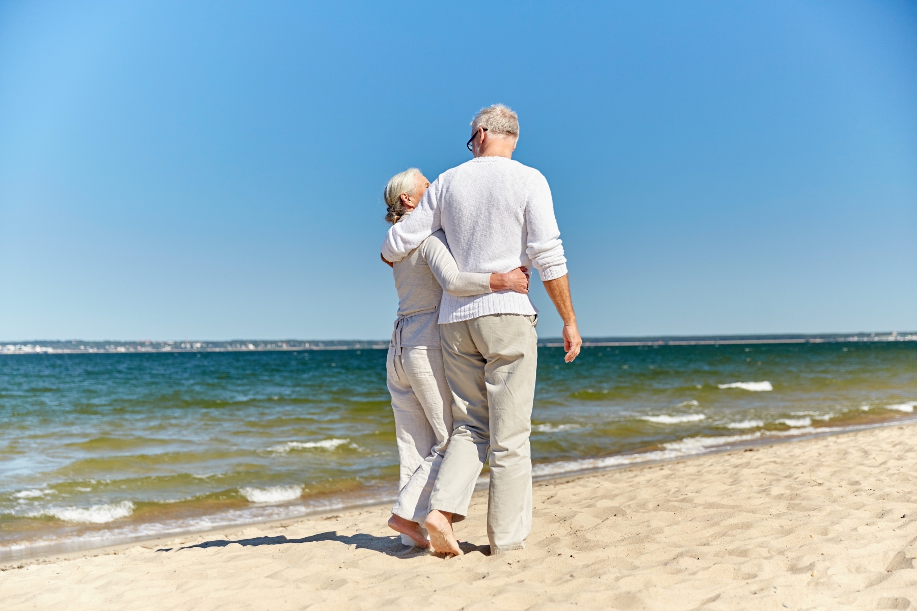 972 18090476 happy senior couple hugging on summer beach
