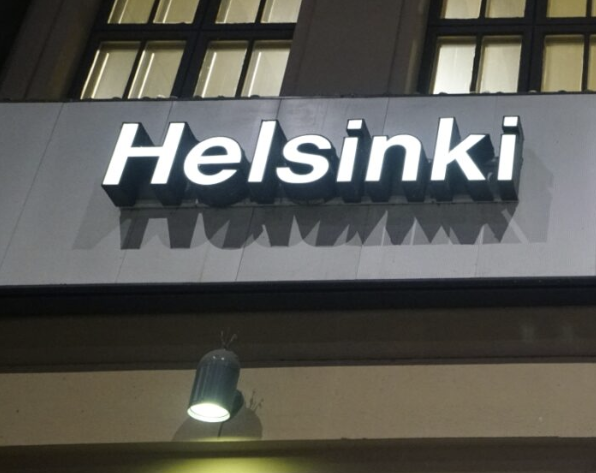 The text Helsinki as a white, big sign on a wall.