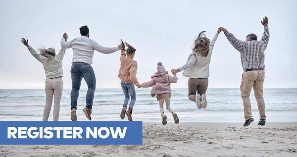 Family in three generations jumping up in the air on a beach
